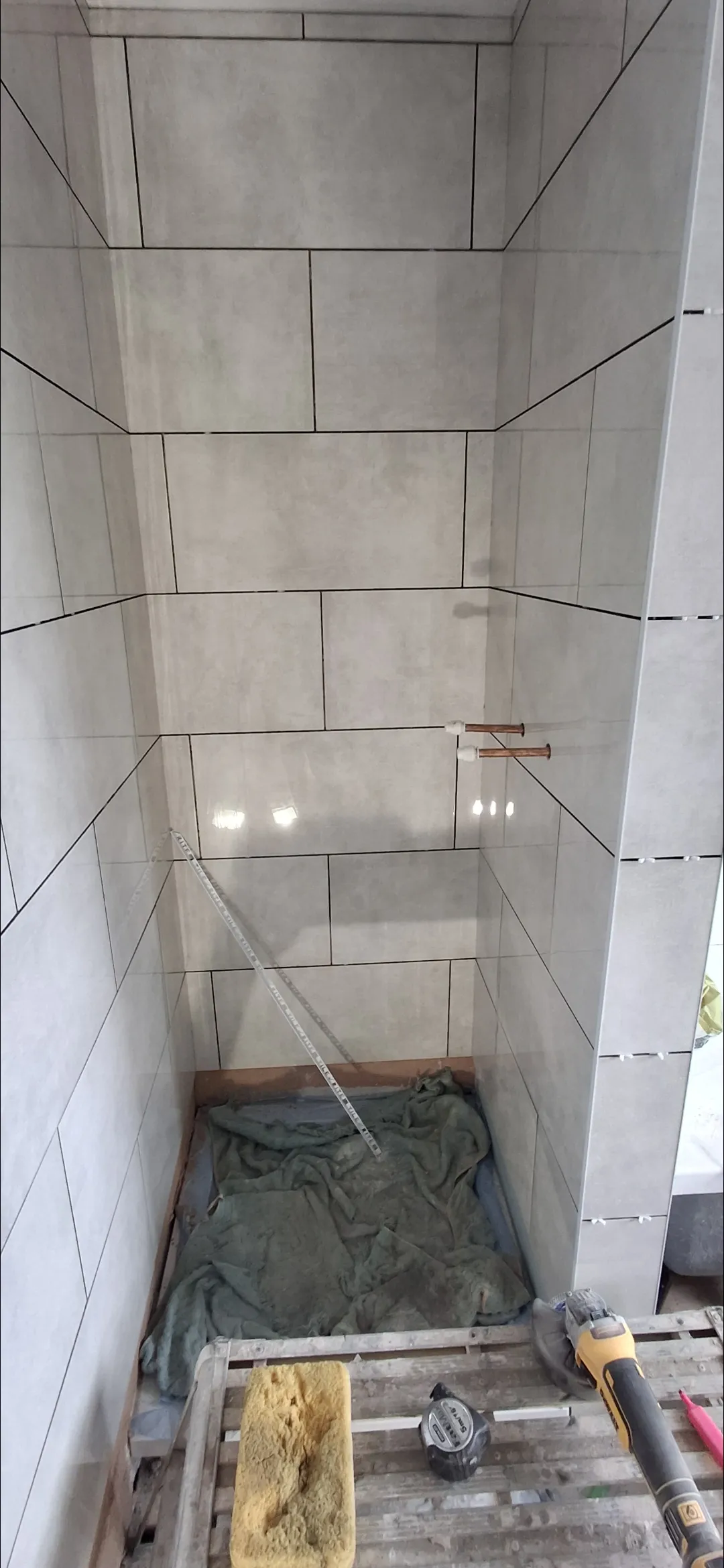 Bathroom blue metro tile shower with glass door and chrome towel rail — bathroom fitters Surrey