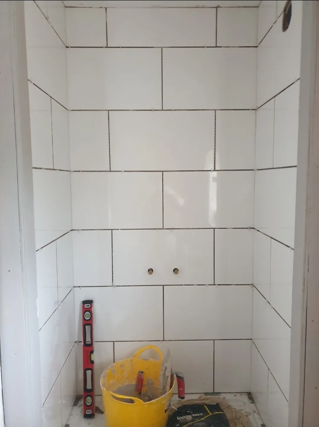 Bathroom white tile shower walls tiling in progress — tilers Surrey