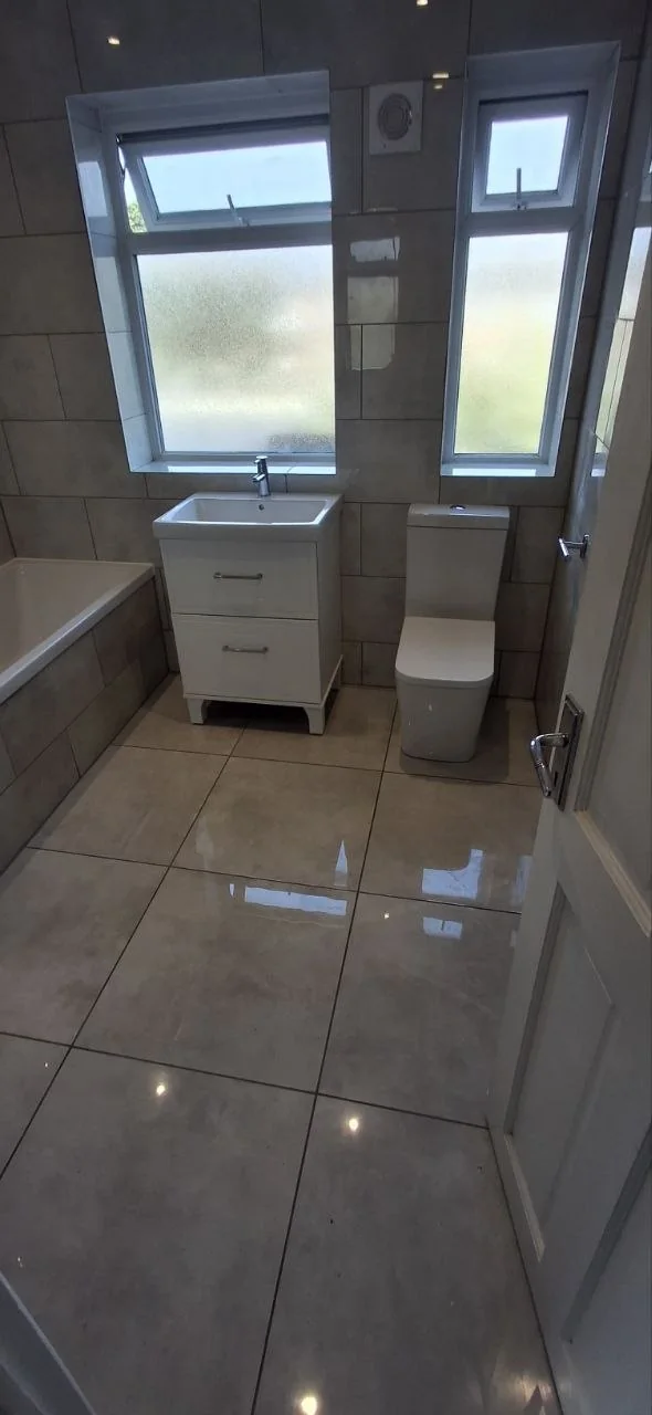 Full bathroom suite installation with grey tiles — bathroom renovation contractors Surrey