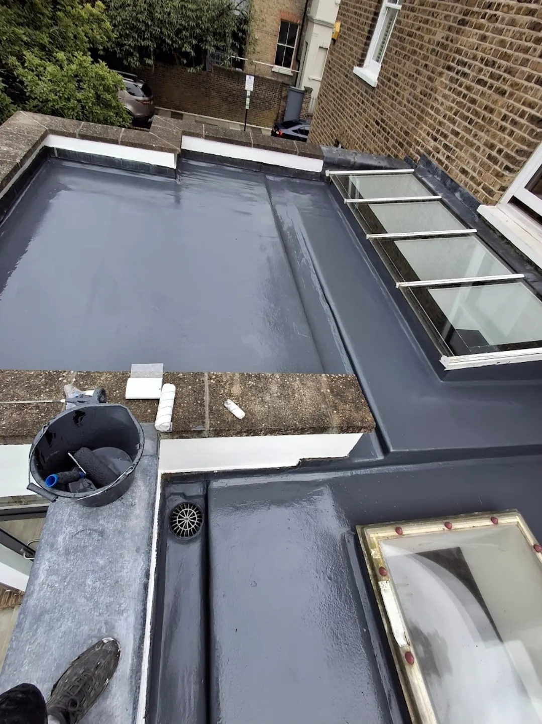 Grey GRP flat roof with glass rooflight lantern on London terrace — flat roof specialists London