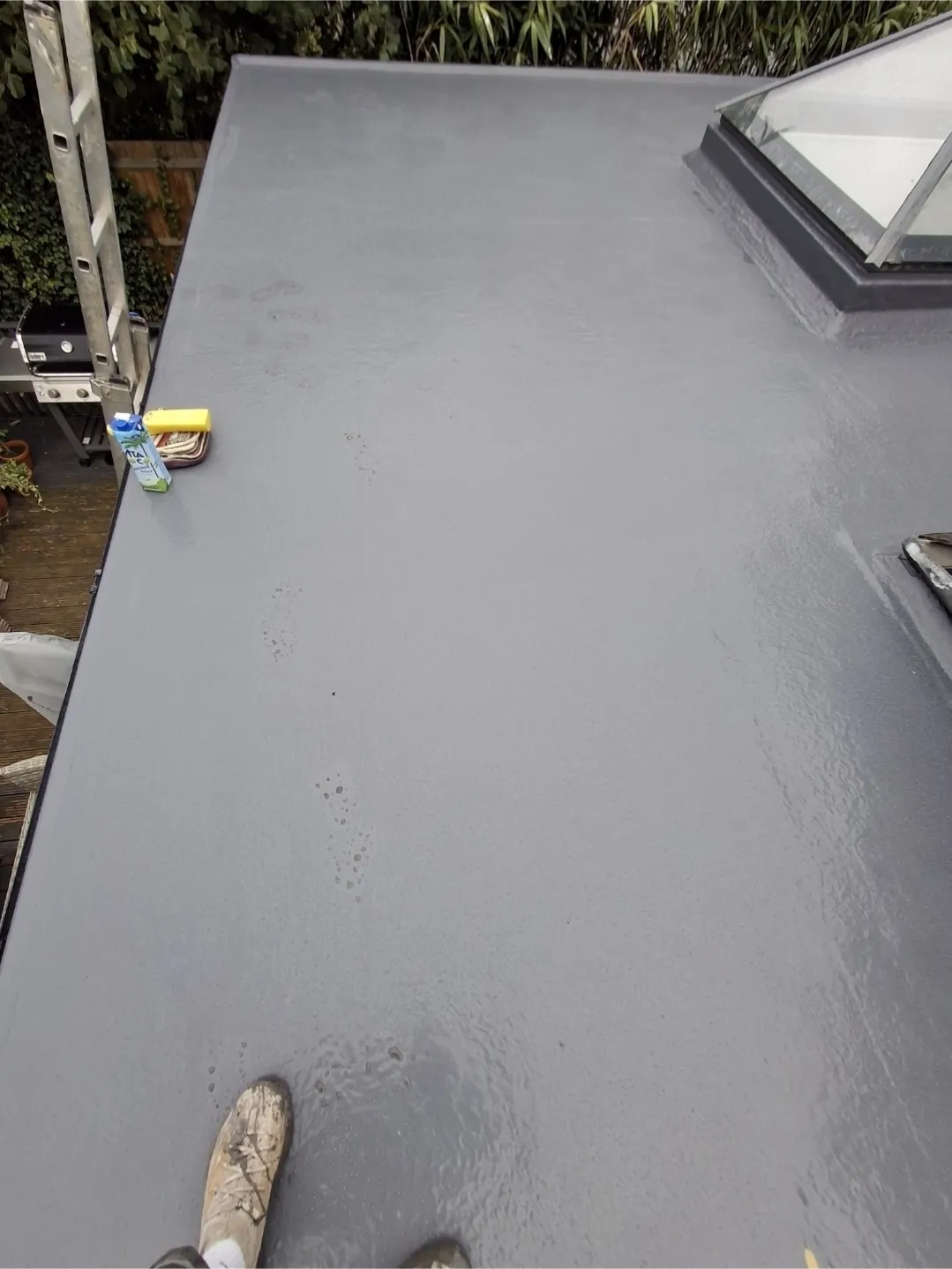 Grey GRP flat roof with rooflight installed — flat roof specialists Surrey