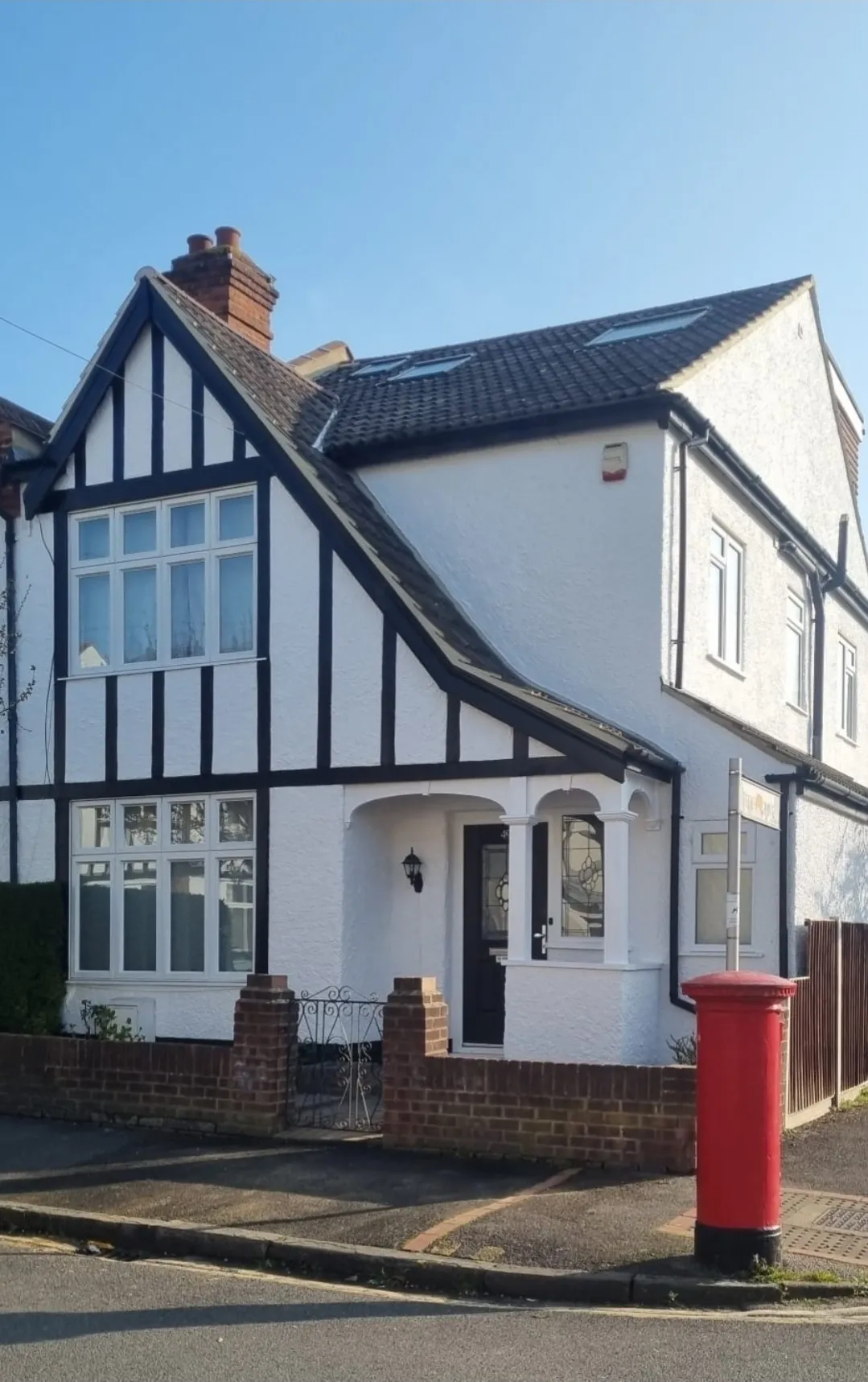 Pitched black tile roof with Velux on tudor house — roofers Richmond Surrey