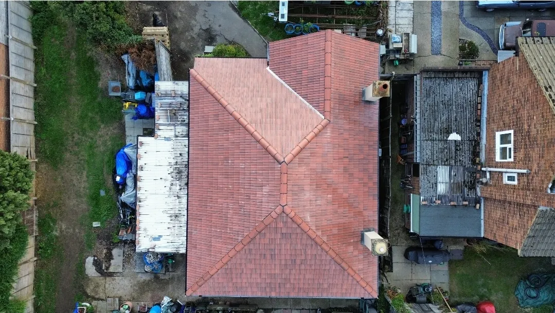Pitched red tile hip roof aerial view — roofers SW London