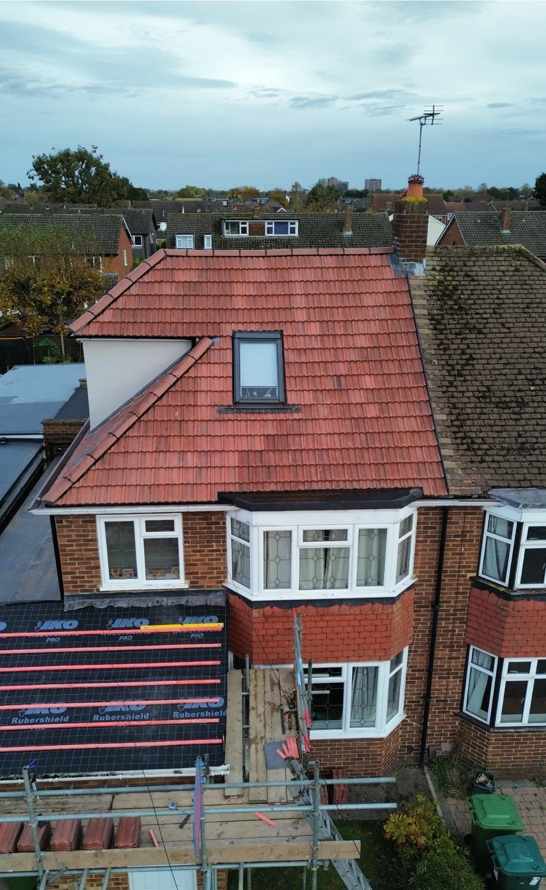 Pitched red tile roof with IKO underlayment in progress aerial — SW London roofers