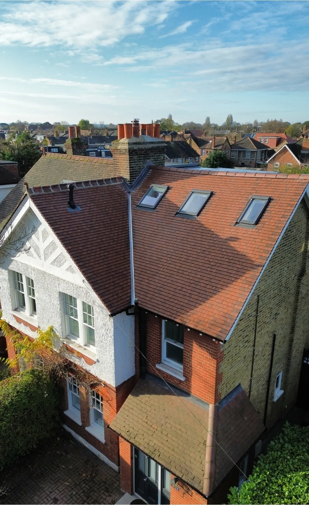 Pitched red tile roof with Velux on Victorian house aerial — roofers Richmond