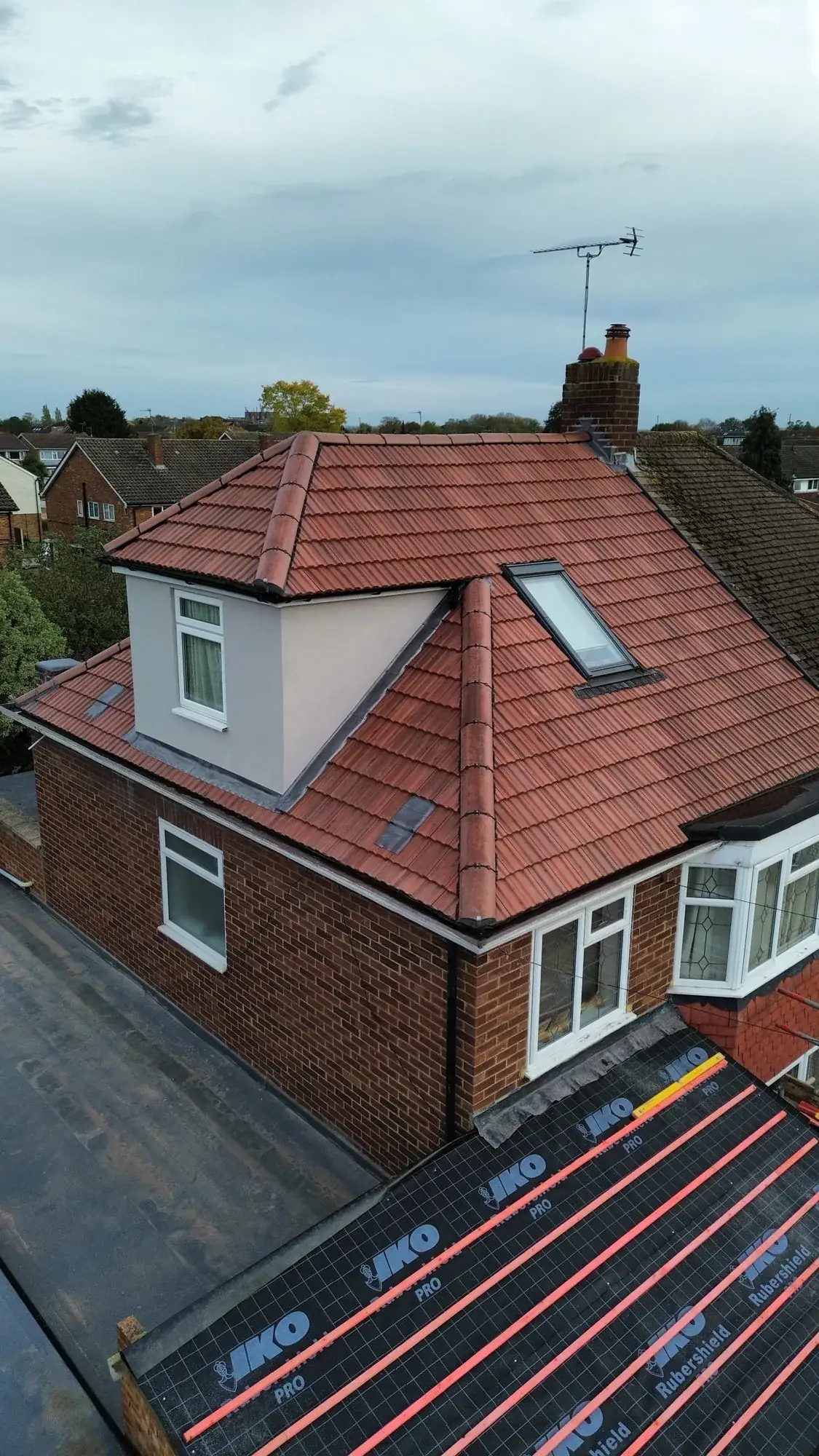 Pitched roof replacement with dormer and Velux installation — roofers Richmond and Surrey